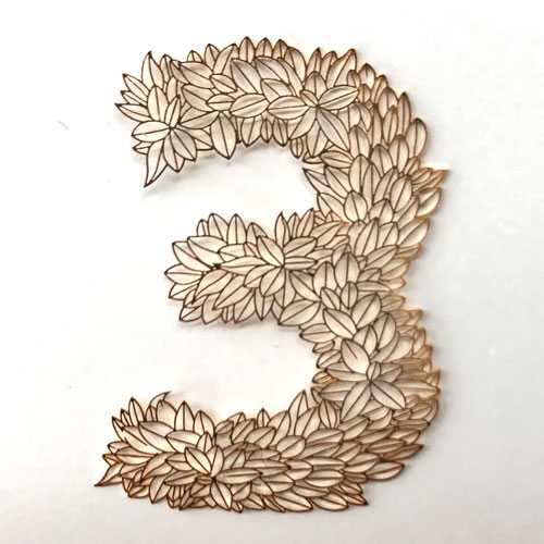 Laser cutting of floral design on gold part with laser cutter